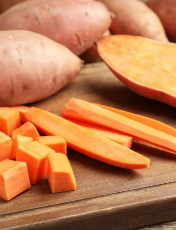 Batatas doces variadas e inhame sobre uma mesa rústica